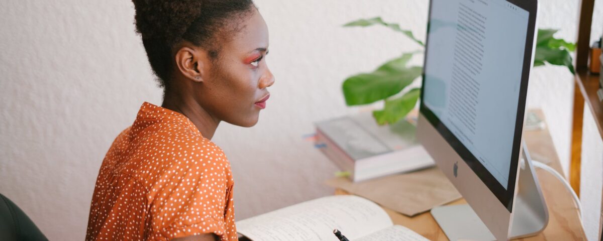 photo of woman looking on computer